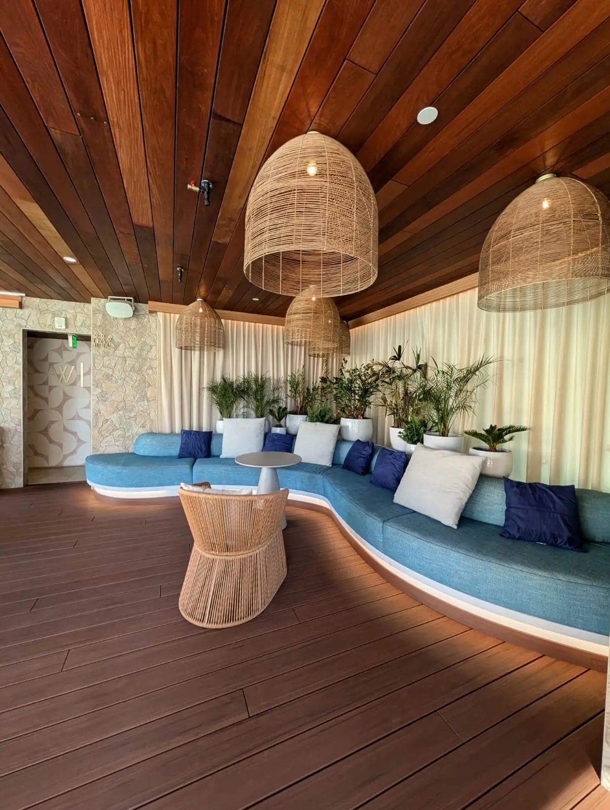Curved blue upholstered hotel lounge seating with decorative cushions