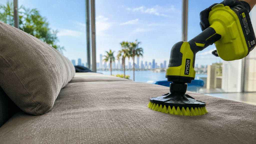 Delicate sofa cleaning with a powered brush on upholstered seating