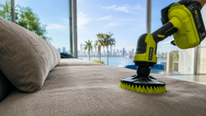Delicate sofa cleaning with a powered brush on upholstered seating