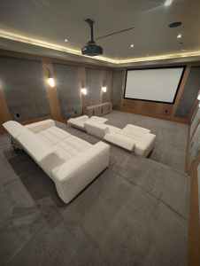 Home theater upholstery cleaning area with white seating and carpet